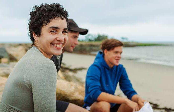 Smiling UB Students on the beach